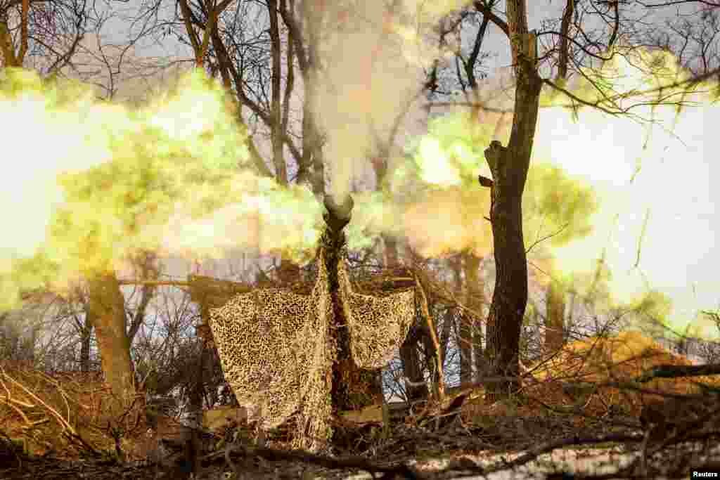 Ukrainian soldiers fire a self-propelled howitzer toward Russian positions at the front line near the town of Chasiv Yar in the Donetsk region. 