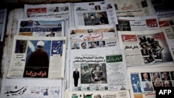 Images of approved and disqualified presidential candidates for the June election appear on the front pages of newspapers at a kiosk in Tehran on May 22.