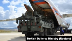 The first parts of a Russian S-400 missile-defense system are unloaded at an air base near Ankara on July 12.