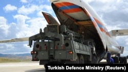 The first parts of a Russian S-400 missile defense system are unloaded from a Russian plane near Ankara on July 12.