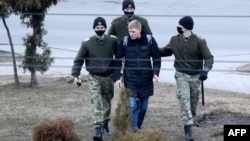 Police detain a man in Minsk on March 25.