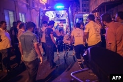 First-aid officers carry an injured man to a hospital in Gaziantep following the attack.