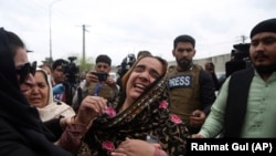 Family members cry after an attack on a Sikh temple in Kabul. (file photo)