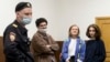 Doxa magazine editors (from left) Armen Aramyan, Natalya Tyshkevich, and Alla Gutnikova wait for a court session in Moscow on April 14, where their "minute of freedom" would be ordered.