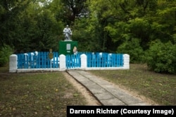 Pirki, Belarus. Inside this freshly painted picket fence are several military graves. Beneath the kneeling soldier a plaque declares “Eternal glory to the heroes who fell in the battles for the freedom and independence of our homeland.”