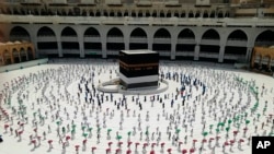 Hundreds of Muslim pilgrims circle the Kaaba, the cubic building at the Grand Mosque, as they observe social distancing to protect themselves against the coronavirus in the Muslim holy city of Mecca on July 29.