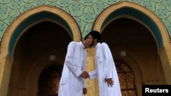 Sunni worshipers exchange greetings after their Eid Al-Fitr prayers to mark the end of the Muslim holy fasting month of Ramadan at a Sunni mosque in Baghdad in August.