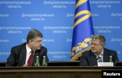 Ukrainian President Petro Poroshenko (left) talks to oligarch Ihor Kolomoyskiy during a ceremony introducing him as the new governor of the eastern Dnipropetrovsk region in Dnipropetrovsk in March 2014.