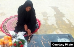 Gohar Eshghi sits next to her son's grave.