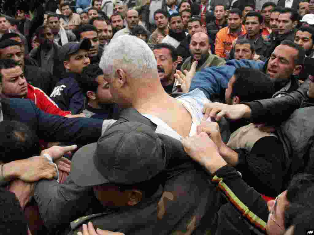 An Egyptian soldier leads away a man suspected of being in President Hosni Mubarak’s secret police on February 4.