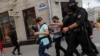 Law enforcement officers are shown detaining journalists in a photograph taken by a Reuters photographer just moments before his own detention in Minsk on July 28.