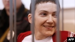 Ukrainian pilot Nadia Savchenko stands inside a defendant's cage during her hearing in the Basmanny district court in Moscow on February 10.