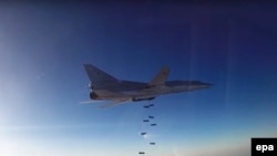 A Russian Tupolev Tu-22M3 long-range bomber dropping off bombs over Syria