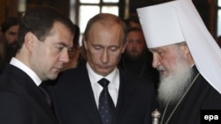 Will Russian President Vladimir Putin (center) use high-profile meetings abroad by Prime Minister Dmitry Medvedev (left) and Orthodox Patriarch Kirill (right) to build real bridges, or to execute tactical moves in a mounting confrontation with the West?