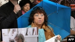 A woman holds pictures of Politkovskaya in Moscow on October 7, the second anniversary of her murder.