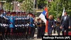 Valentina Matviyenko, speaker of the Federation Council, Russian parliament's upper chamber (center) reviews an honor guard with Milorad Dodik, president of Republic Srpska