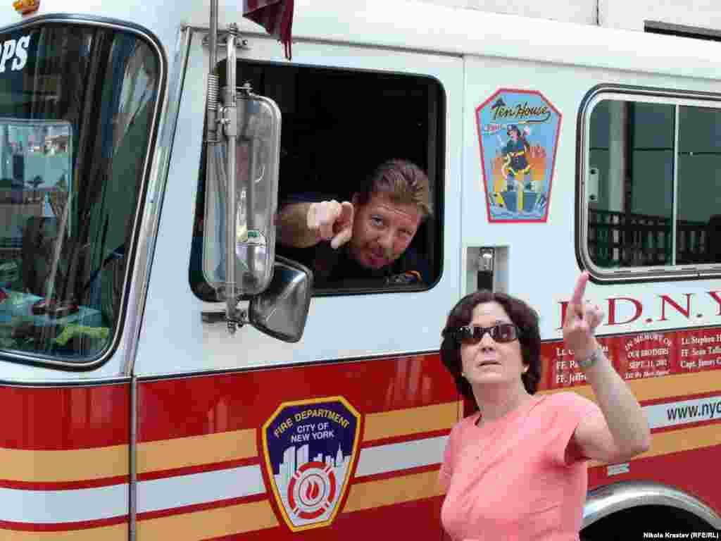 A firefighter gives directions to a tourist visiting the redeveloped World Trade Center. Always a busy neighborhood, the area is now expected to attract droves of tourists.