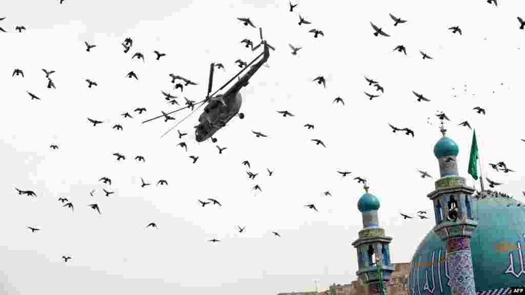 An Afghan National Army helicopter flies over the Sakhi Shrine in Kabul.