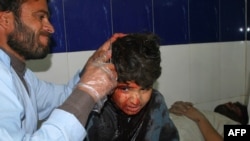 A paramedic treats an injured boy at a Quetta hospital following a car bomb blast on December 30 that killed at least eight people.