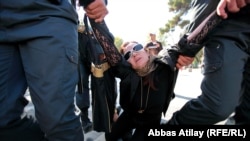 Security forces apprehend an opposition protester in Baku.