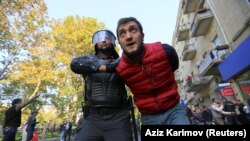 A man is detained during a rally in Baku on October 20.