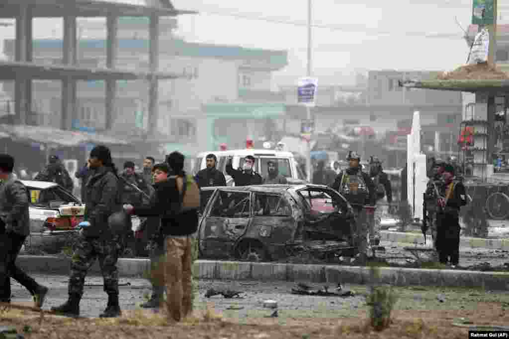 Afghan security personnel inspect the site of the explosion, which occurred as the Wardak&#39;s convoy was passing through an intersection in Kabul&#39;s Khushal Khan neighborhood.