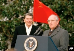 Soviet leader Mikhail Gorbachev and U.S. President Ronald Reagan (left) speak to the press in Washington on December 8, 1987.