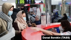 Passengers and railway station employees wear protective masks in the Russian city of Yekaterinburg earlier this week. 