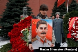 A woman holds a picture of a Soviet leader Josef Stalin during a ceremony marking the 66th anniversary of his death in Moscow's Red Square on March 5.