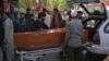 Relatives load the coffin of a victim of twin suicide bombs that killed scores of people outside Kabul airport in August 2021. The attack was claimed by the Islamic State-Khorasan militant group. 