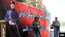 Afghan police stand beside a portrait of former Afghan King Ghazi Amanullah Khan during Independence Day celebrations in Jalalabad.