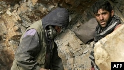 Afghan miners drill into rock in a makeshift emerald mine in the Panjshir Valley (file photo)