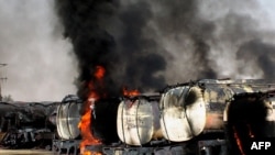 Trucks carrying fuel for NATO forces in Afghanistan burn following an attack by militants in the remote Mitri area of Pakistan.