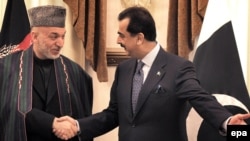 Pakistan's Prime Minister Yousuf Raza Gilani (right) with Afghan President Hamid Karzai in Islamabad in March