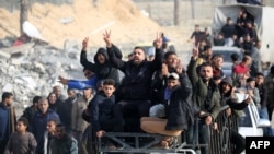 Displaced Palestinians cheer as they return to Rafah in the southern Gaza Strip on January 19.