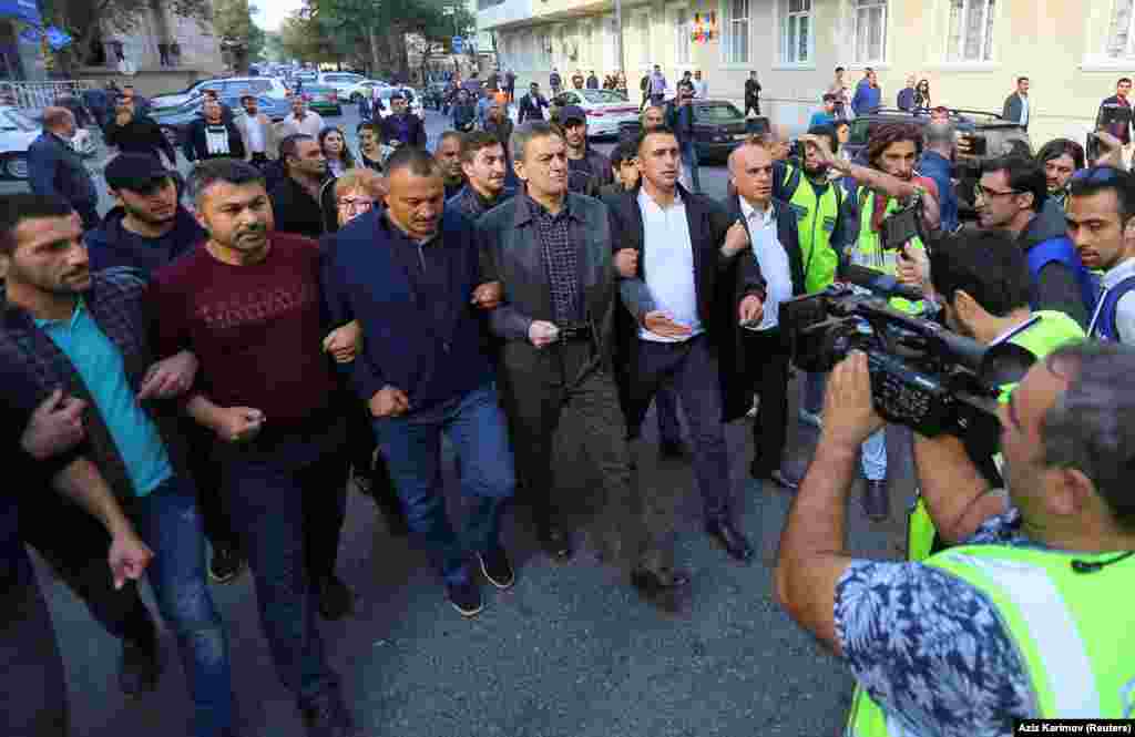 Opposition figures, including Ali Keremli (center, in gray jacket) marching in Baku. Keremli was later arrested and, he said, tortured in custody.