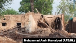 Residents collect their belongings from the ruins of their house, which collapsed due to floodwaters, after heavy rain in Pakhtunkhwa province, on August 1.