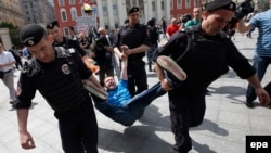 Police officers detain a protester in Moscow last year. According to Freedom House, 2015 saw Russia and other authoritarian regimes "crack down harder on dissent."