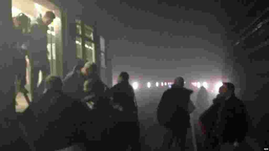 Passengers leave a metro train between the Arts-Lois and Maelbeek metro stations after an explosion at Maalbeek station in central Brussels.