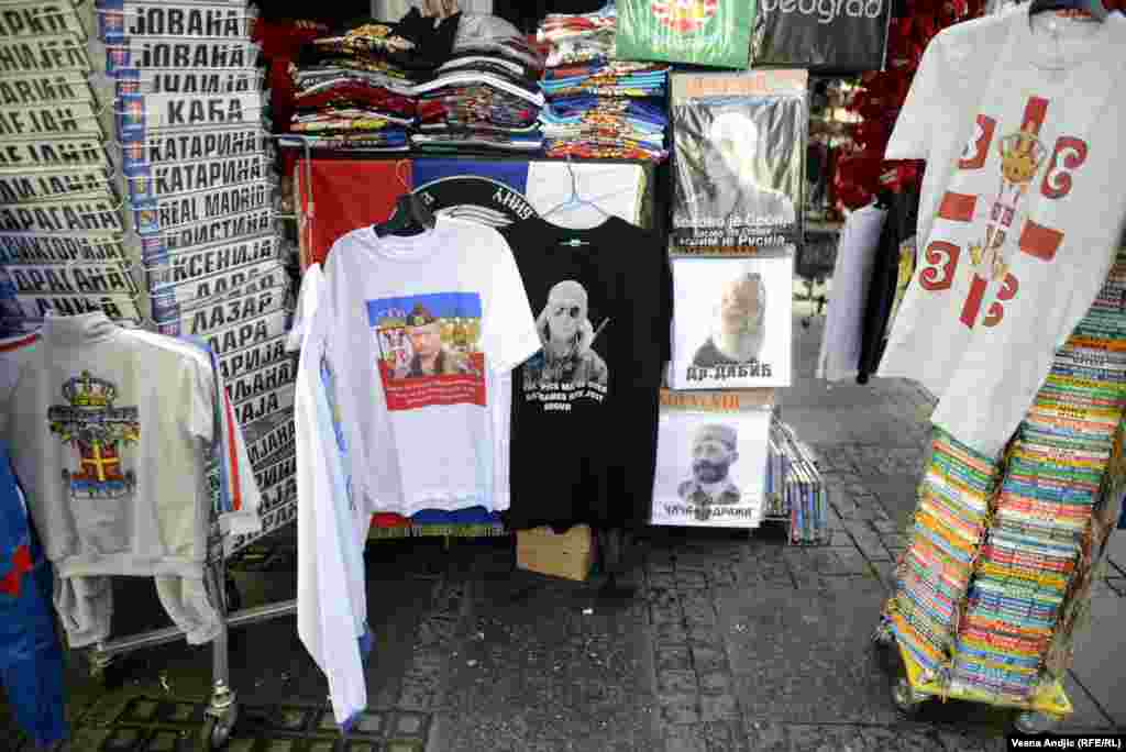 More Putin T-shirts, but not in good company. One T-shirt to Putin&#39;s right features &quot;Dr. Dabic,&quot; the pseudonym under which 1990s Bosnian Serb leader Radovan Karadzic evaded justice for nearly 13 years before his arrest in 2008. 