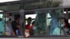 People wearing protective face masks ride a bus in Ashgabat, despite the country officially having had no cases of COVID-19.