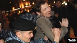 Police detain a protester in Moscow on October 12.