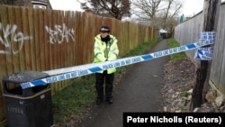 A police officer stands behind cordon near the home of Russian ex-spy Sergei Skripal in Salisbury, England.