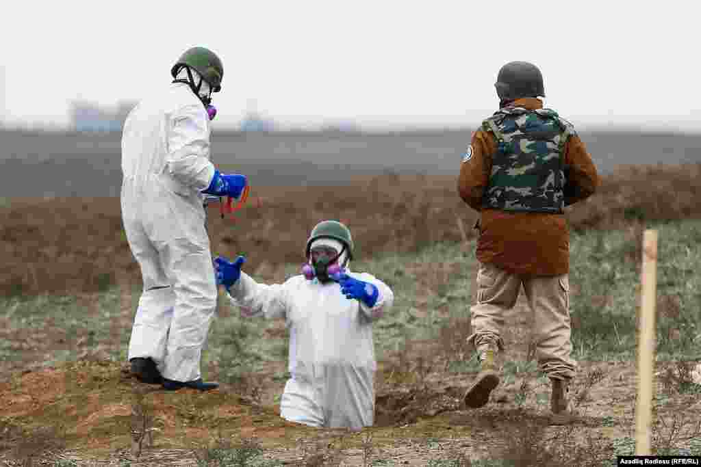 Azerbaijani mine-clearance officers prepare to detonate unexploded munitions.&nbsp;