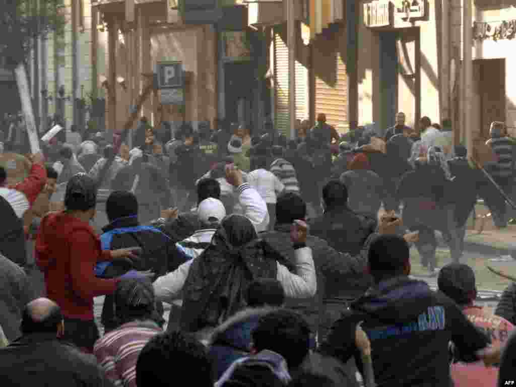 Mubarak supporters attack opposition protestors during clashes on Tahrir Square.