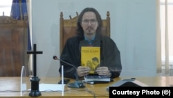 Romania Judge Cristi Danilet poses with his book The Student And The Law. (file photo)