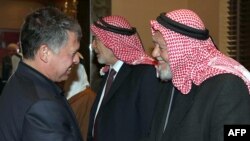 Jordan's King Abdullah II (left) shakes hands with Hamzi Mansour, leader of the Islamic Action Front, during a meeting in Amman on February 3.