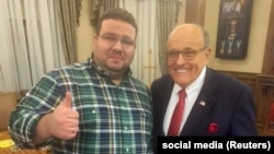 Political consultant Andriy Telizhenko (left) with Rudy Giuliani in Kyiv on December 5.