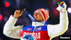 Russian gold medalist Aleksandr Legkov celebrates as he receives his medal for the men's cross-country 50-kilometer mass start race during the closing ceremony for the Sochi 2014 Winter Olympics in February 2014.