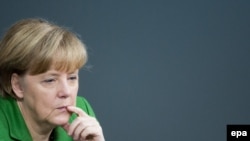 German Chancellor Angela Merkel listens to a speech during a Bundestag session in Berlin, 18 November 2013.